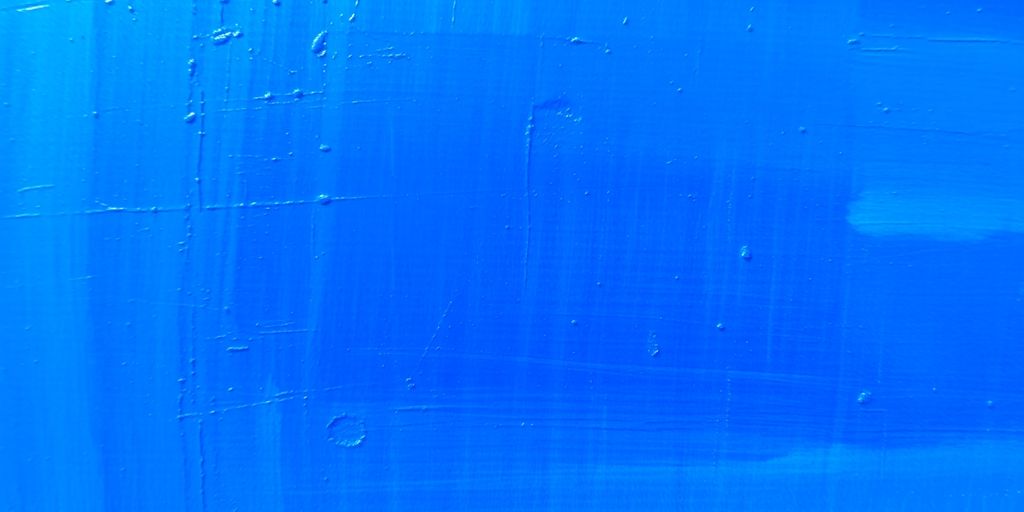 Close-up of a vibrant blue oil painting.