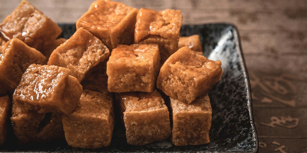 Fried tofu cubes are piled on a plate.