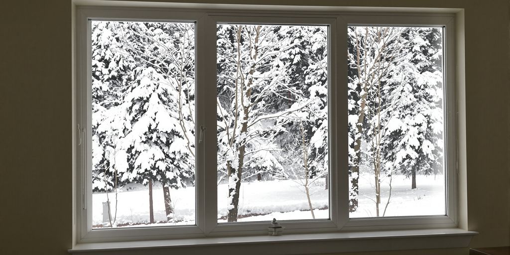 Cozy living room interior looking out a large, energy-efficient window.