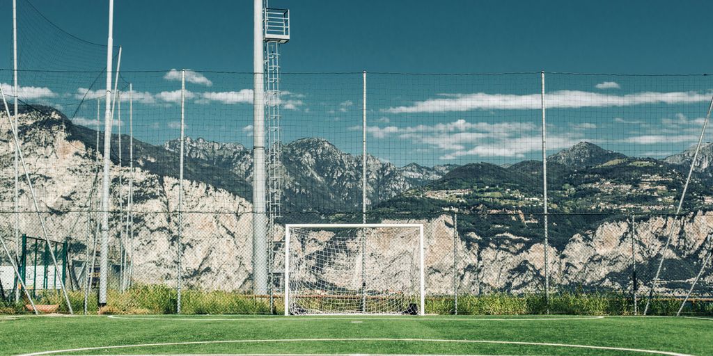 soccer field in distant of mountain