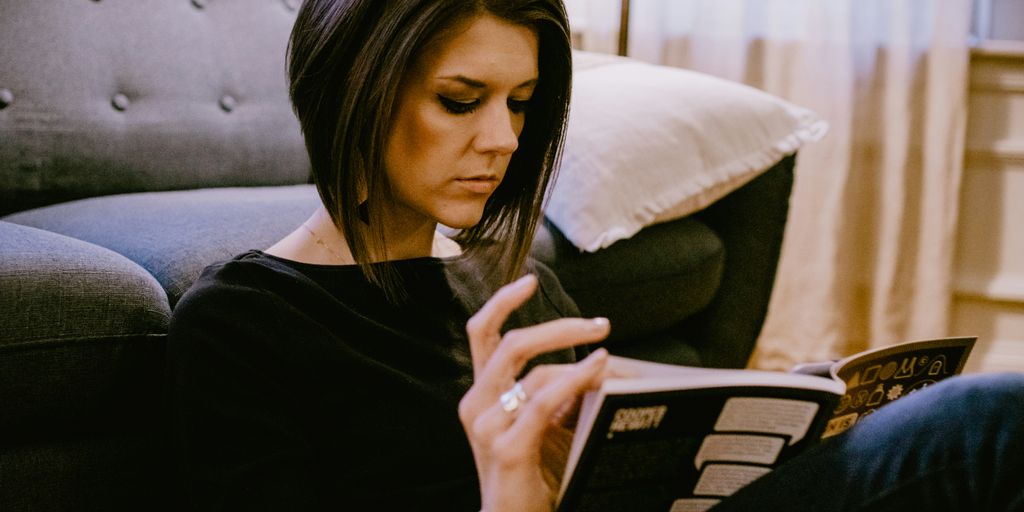 woman in black long sleeve shirt sitting on couch