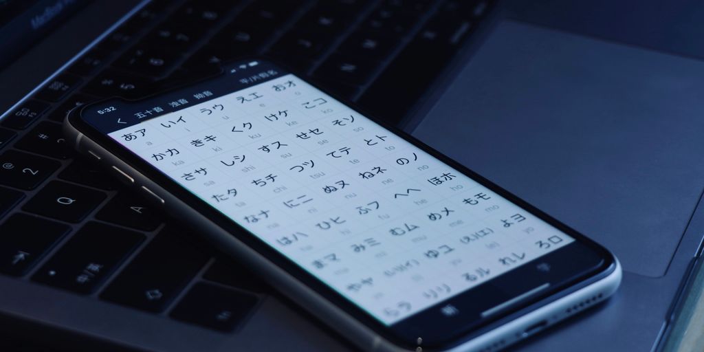 black android smartphone on laptop computer