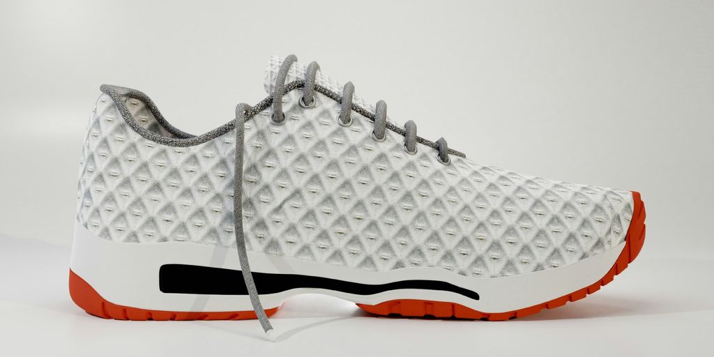 a white and orange sneaker on a white background