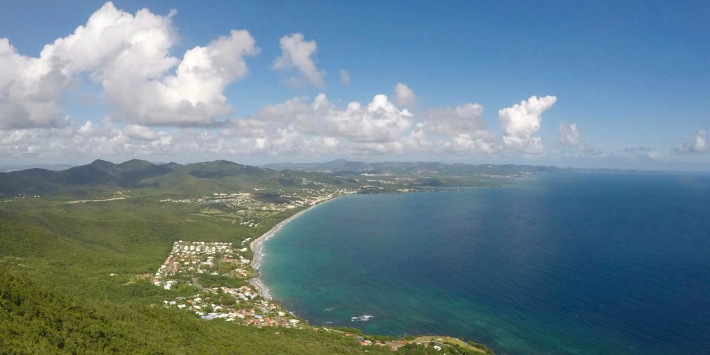 a scenic view of a tropical island and the ocean