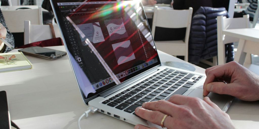 a person using a laptop computer on a table