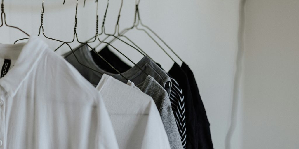 assorted-color shirt hanging beside wall