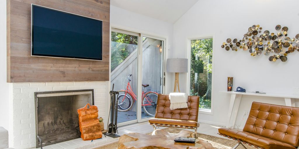 two tufted brown leather chairs in front of brown wood stump center table