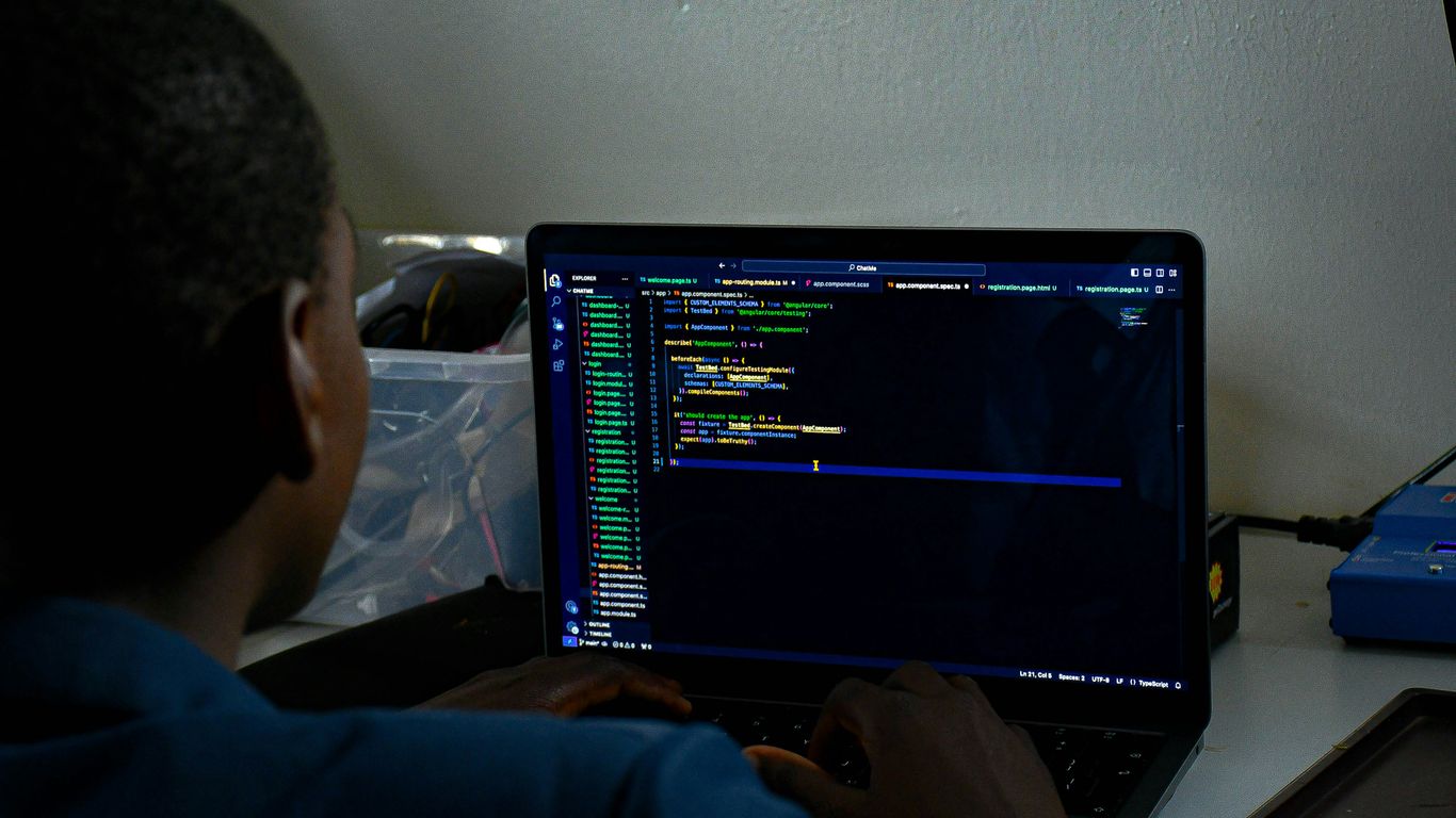 a man sitting in front of a laptop computer