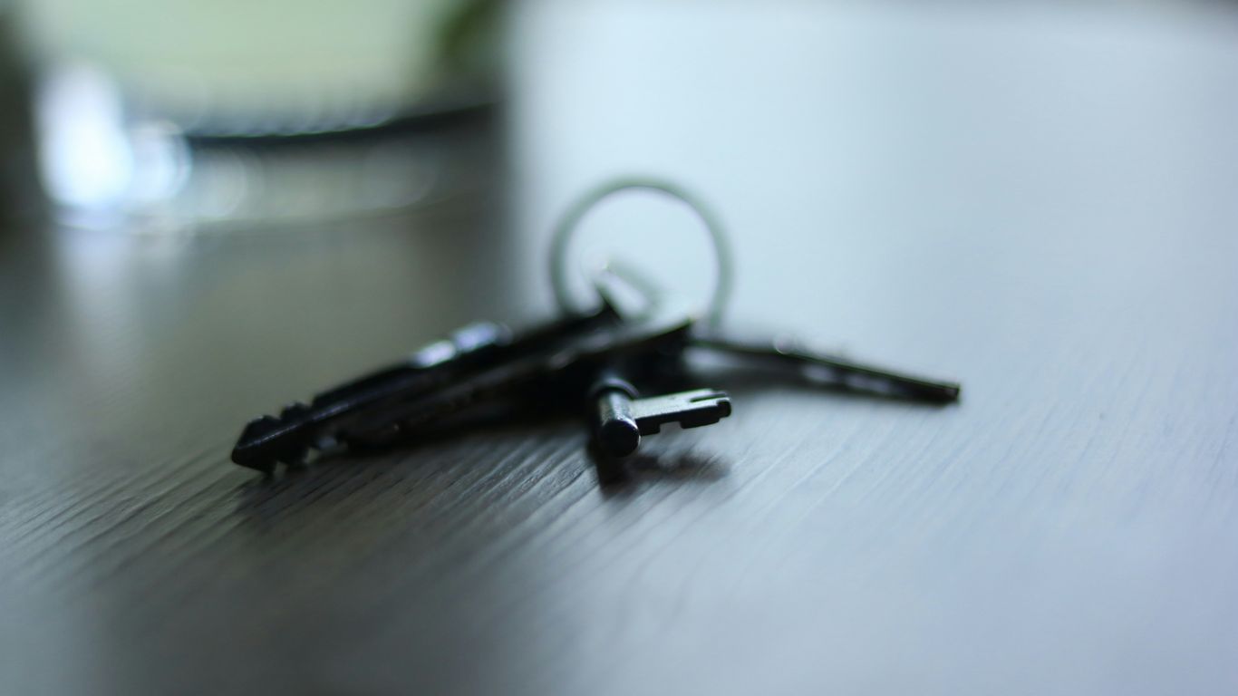 Scissors and paperwork on a wooden table, symbolizing post‑closing setup tasks