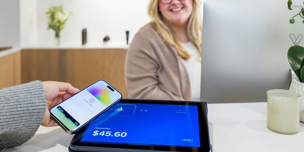 A phone is used to pay at the counter.