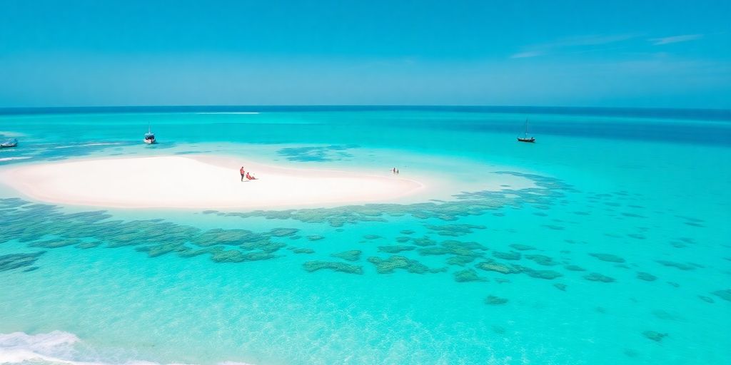 Pristine white sandbank surrounded by turquoise ocean under blue sky.