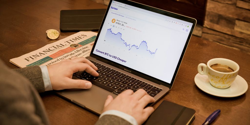 a person typing on a laptop on a table
