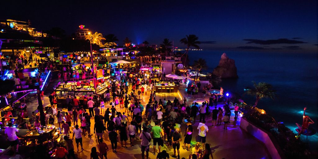 Cabo San Lucas nightlife with colorful lights and dancing.