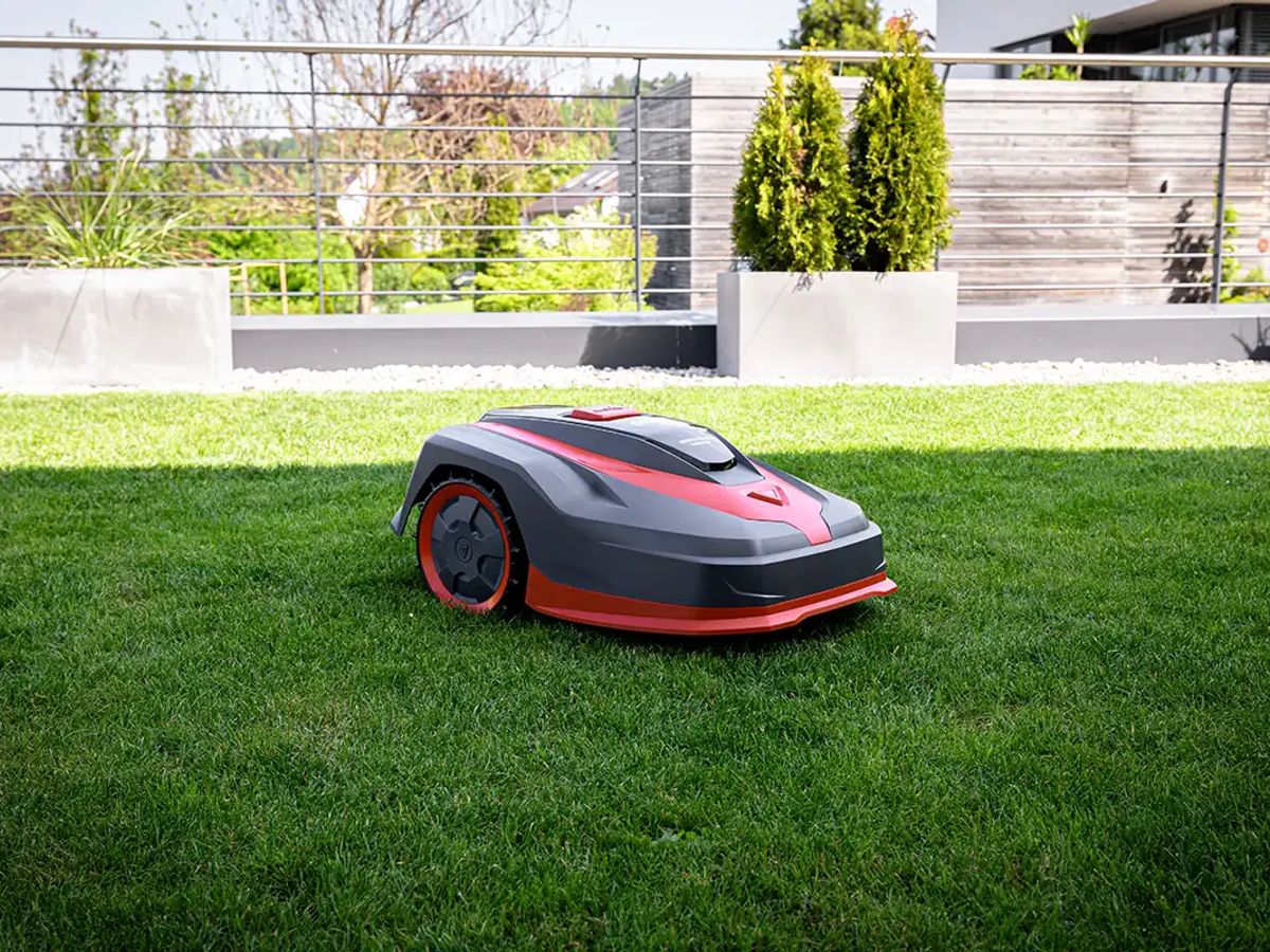 A robotic lawn mower on a green, well-maintained lawn.