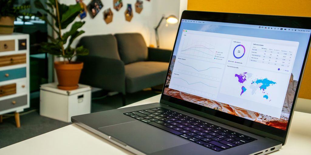 a laptop computer sitting on top of a white table