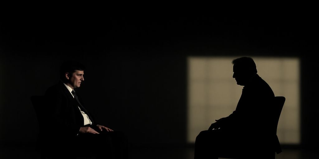 FBI agents in a dimly lit interview room.
