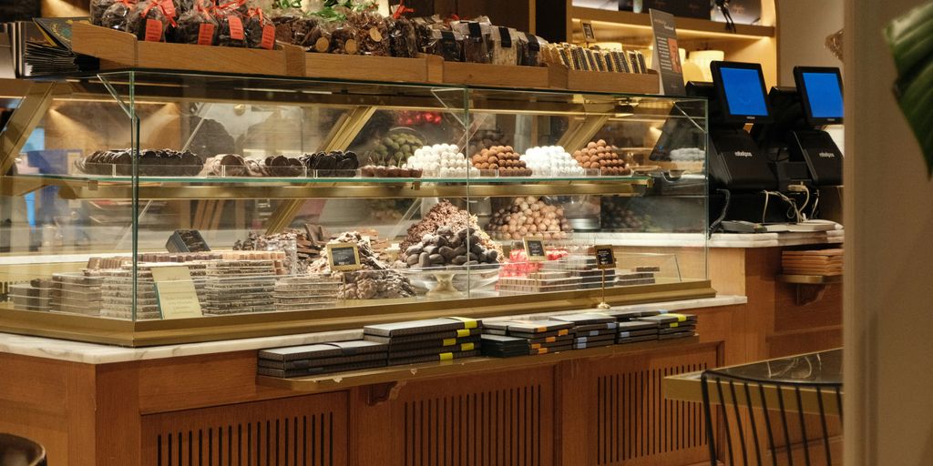 a bakery filled with lots of different types of cakes