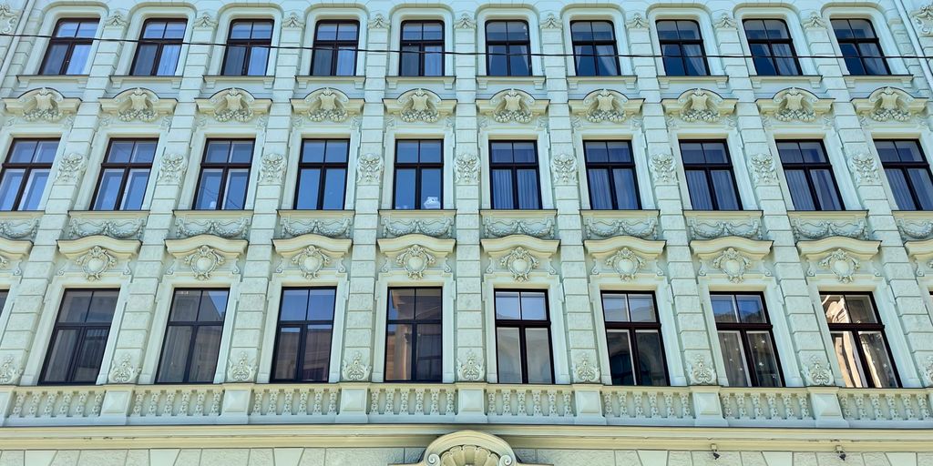 a large white building with many windows and a clock