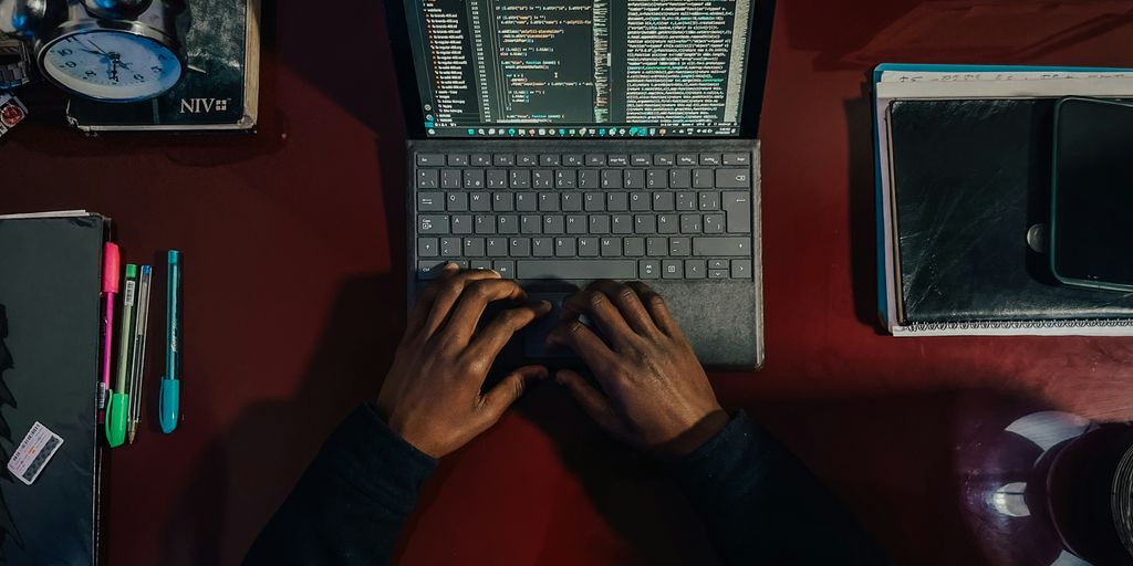 A person sitting at a desk with a laptop