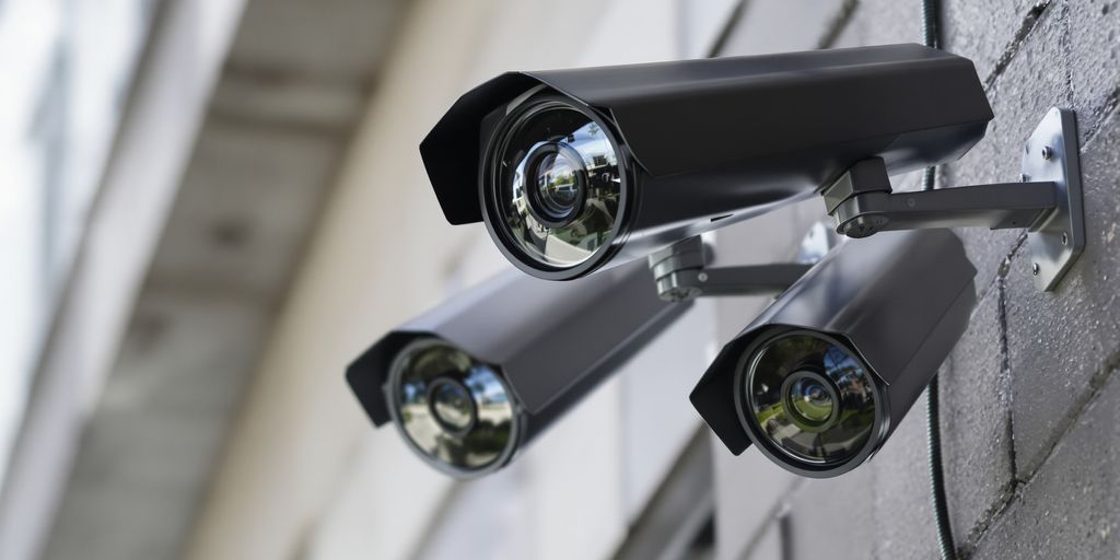 Surveillance cameras mounted on a building.