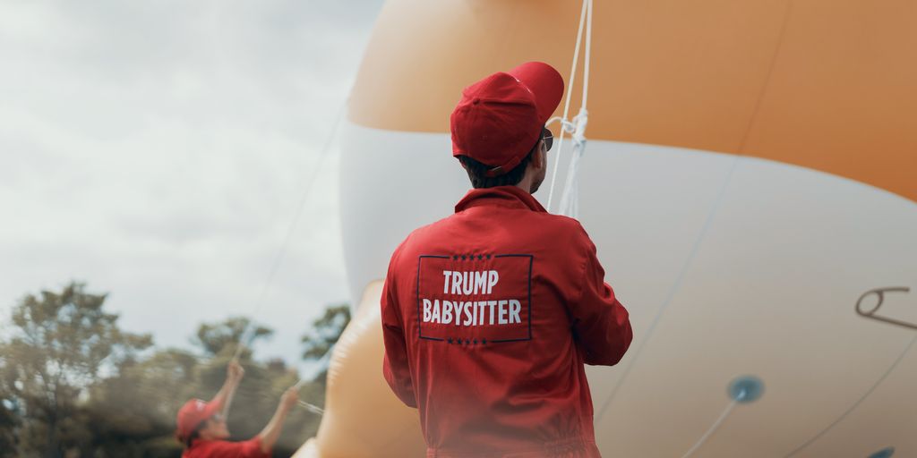 person in red cap and red long-sleeved top holding rope
