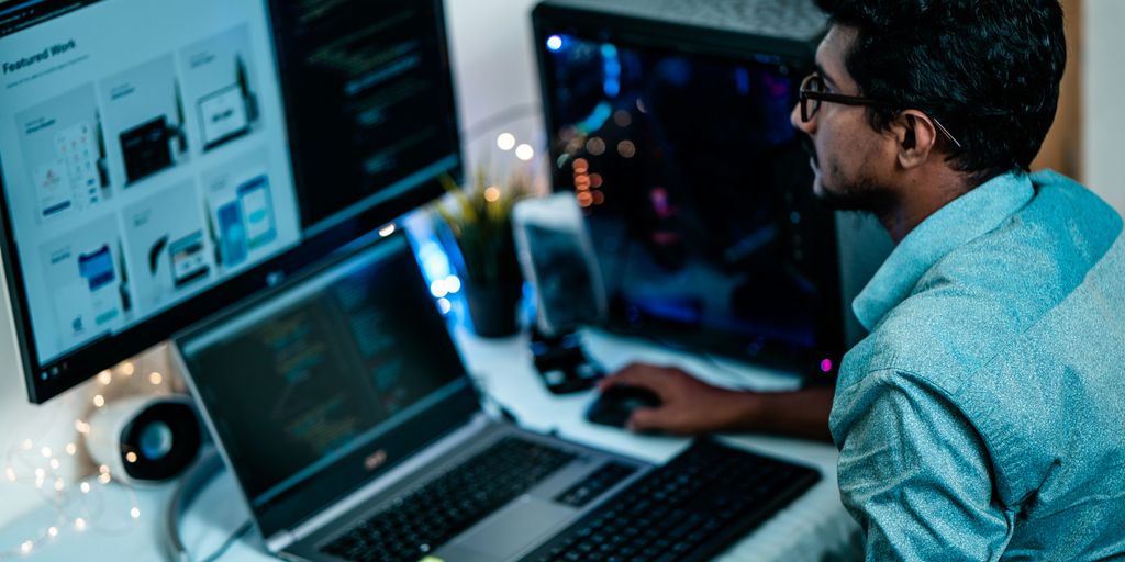 man in blue dress shirt using computer