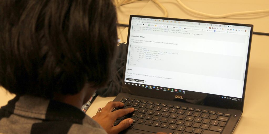 a person sitting in front of a laptop computer