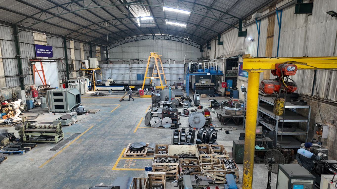 Spacious industrial workshop filled with machinery and equipment.