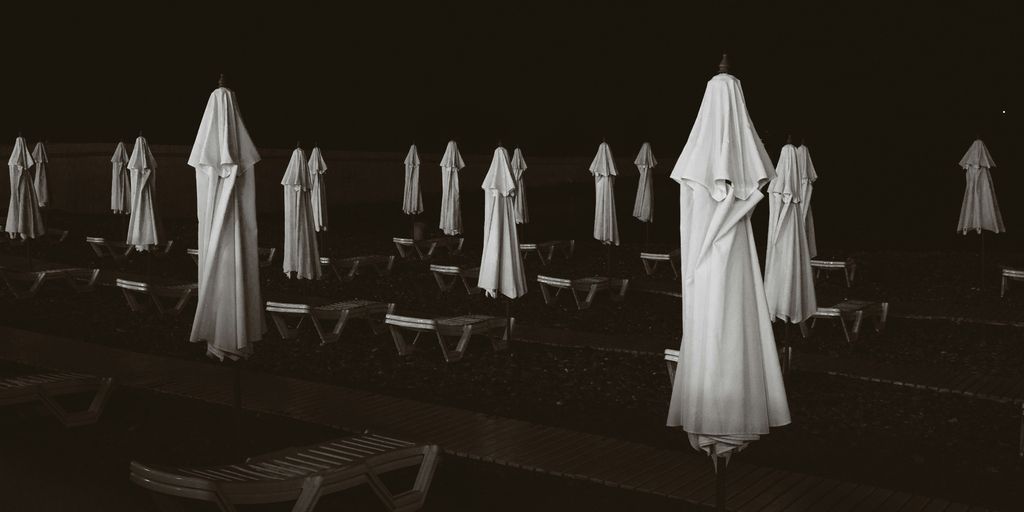 a row of white umbrellas sitting next to each other