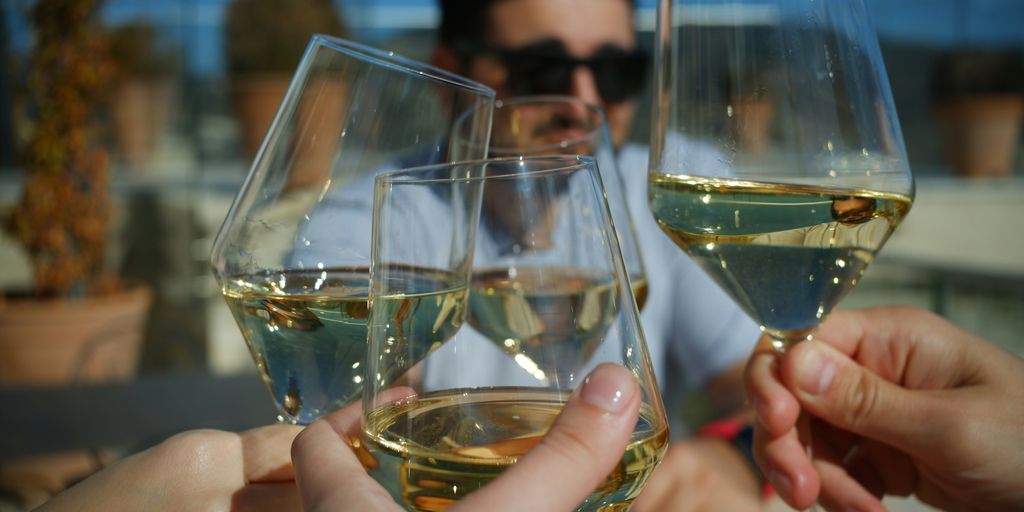 a group of people toasting with wine glasses
