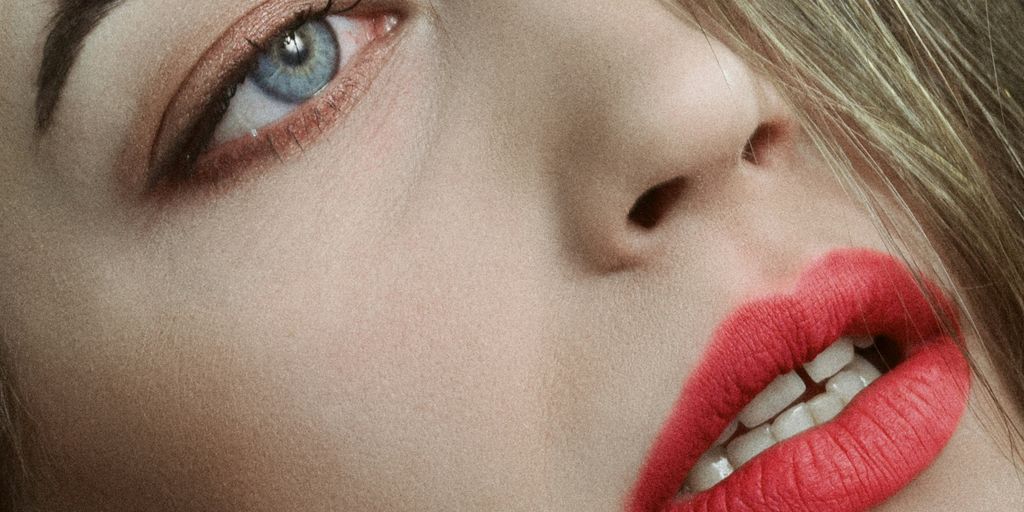 a close up of a woman with red lipstick
