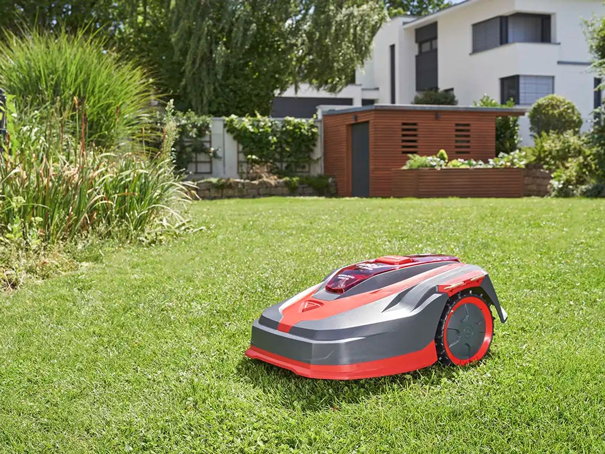 A robotic lawn mower on a green grassy lawn.