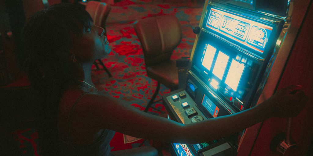 a woman playing a slot machine in a casino