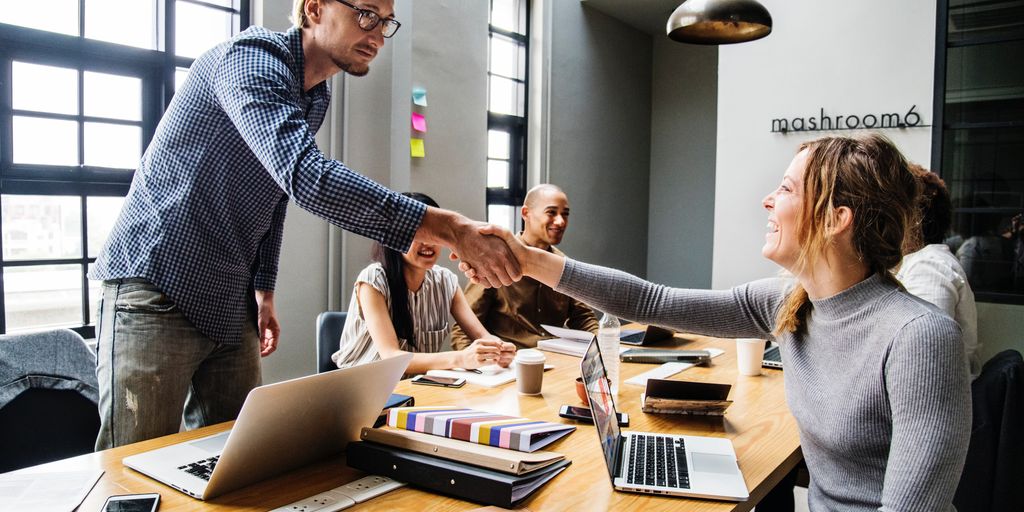 diverse group of professionals collaborating in a modern office, showcasing teamwork and communication