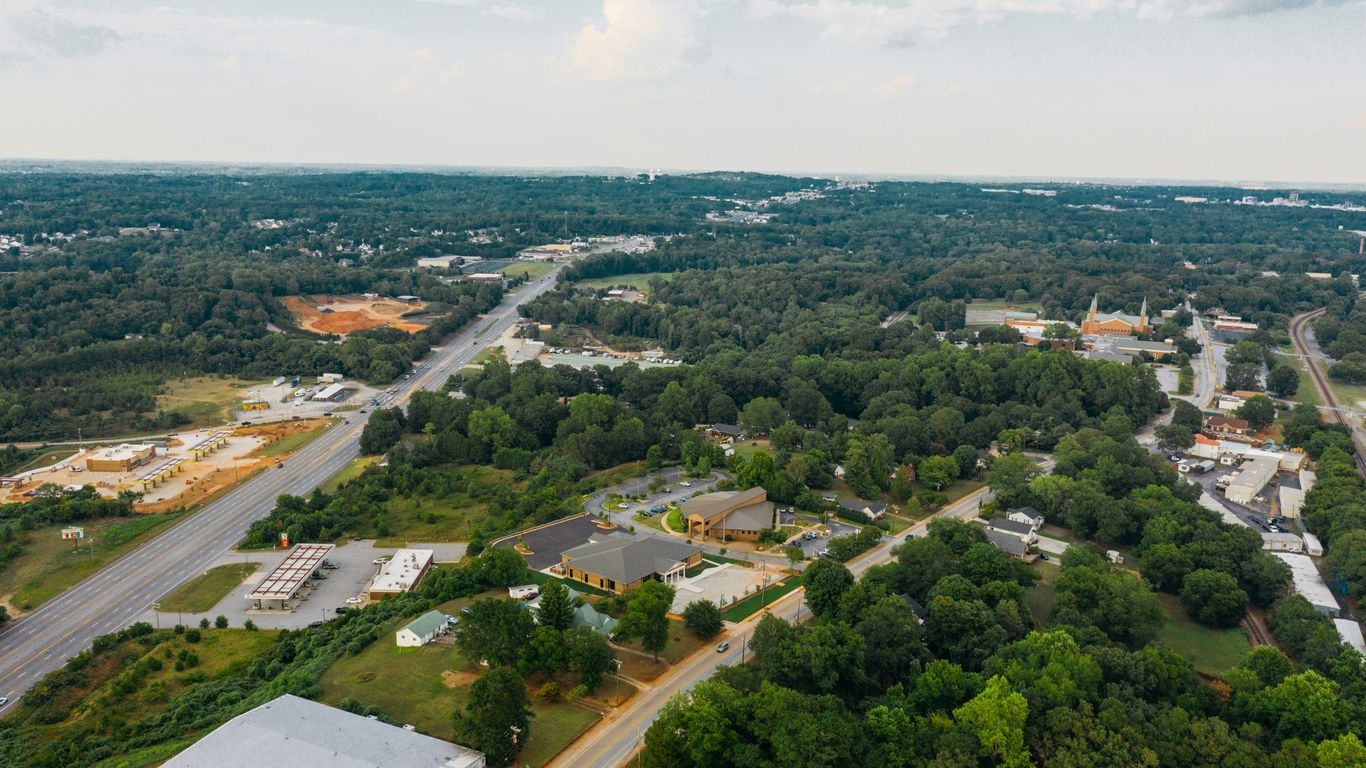 an aerial view of a small town surrounded by trees