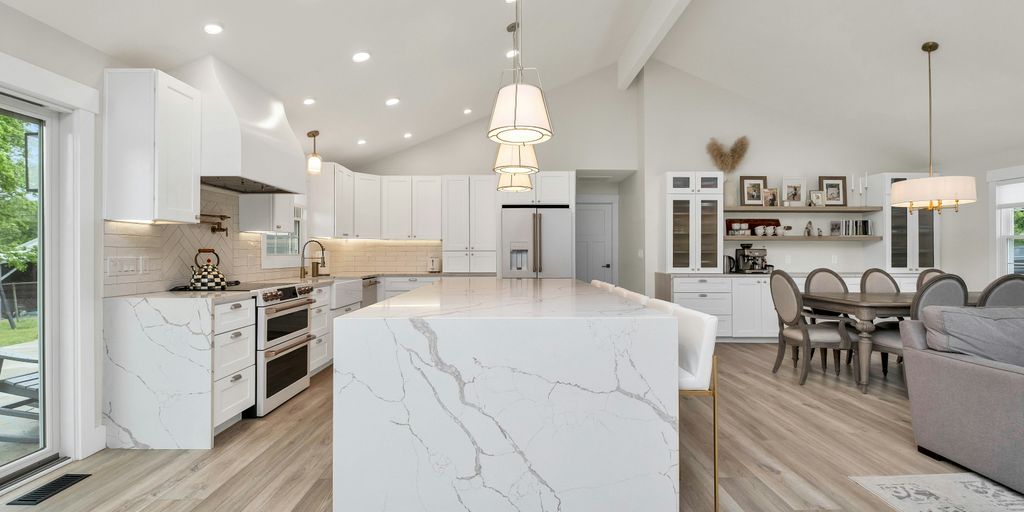 a large kitchen with a center island in the middle of the room