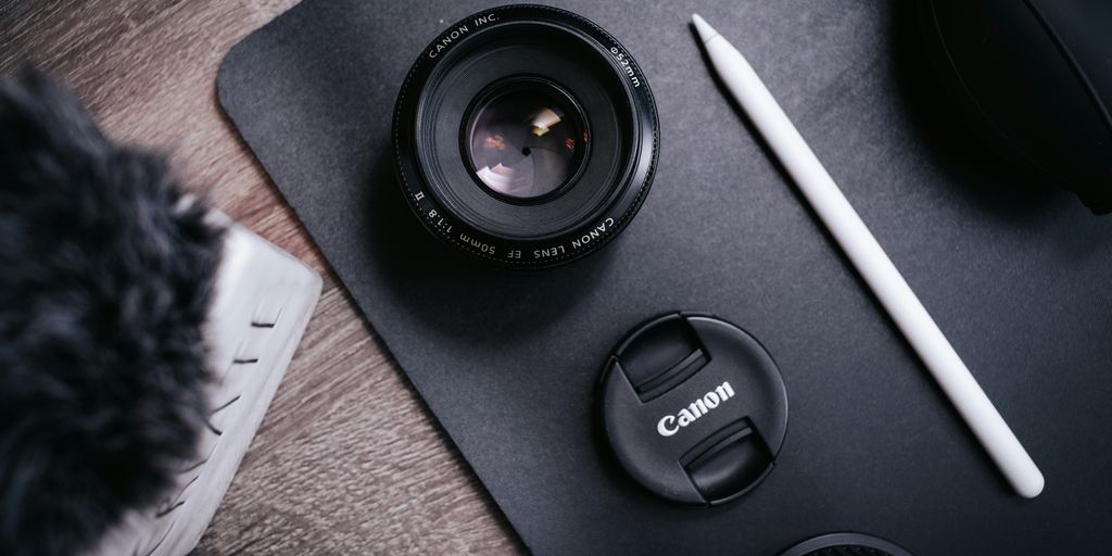 black camera lens on black laptop computer