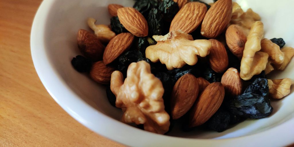 brown and black nuts on white ceramic bowl