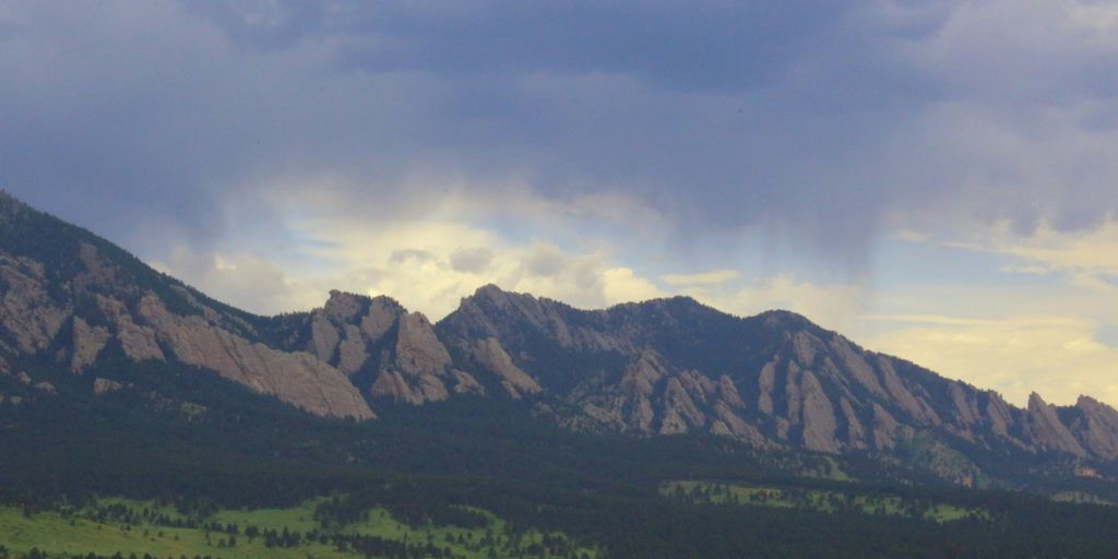 wide field grass distance with mountains during daytime