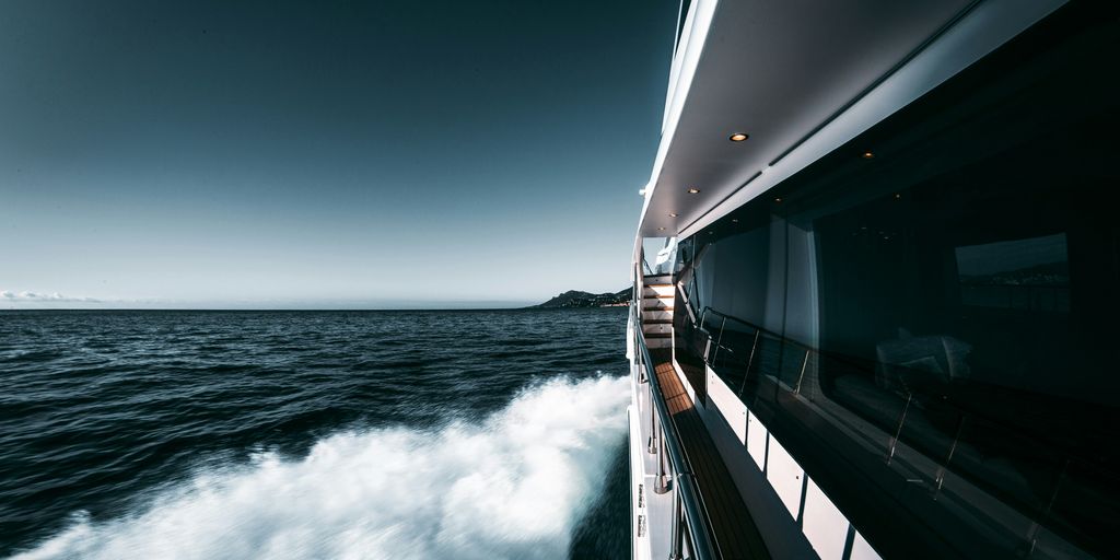 white and black ship on sea under blue sky during daytime