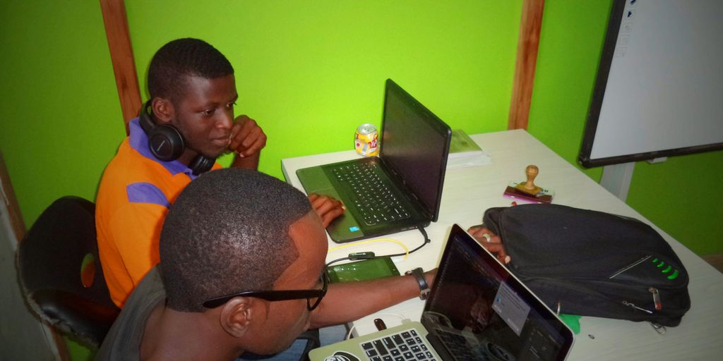 two men using laptop computes