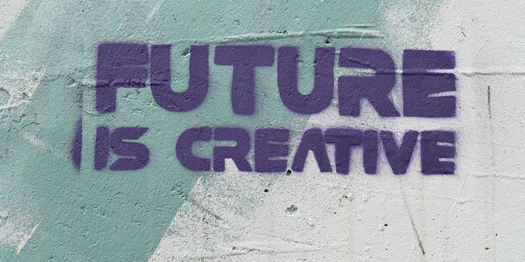 a graffiti on a wall that says, future is creative