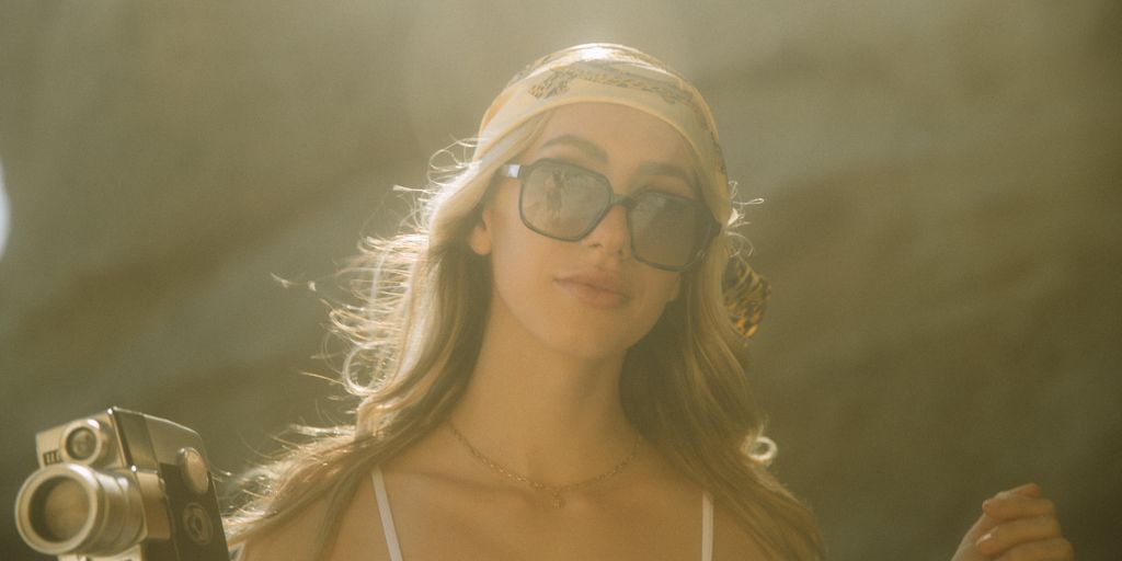 woman in white spaghetti strap top wearing aviator sunglasses