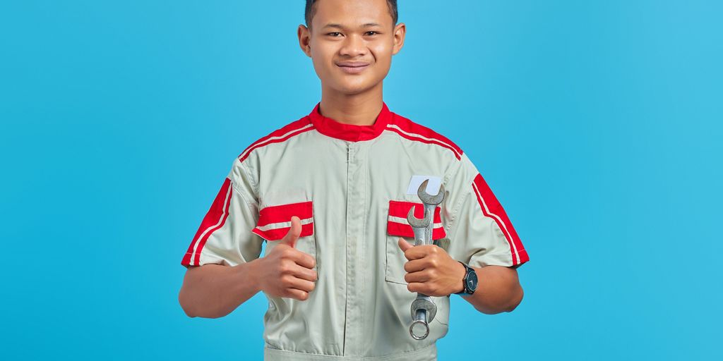 a man holding a pair of wrenches in his hands