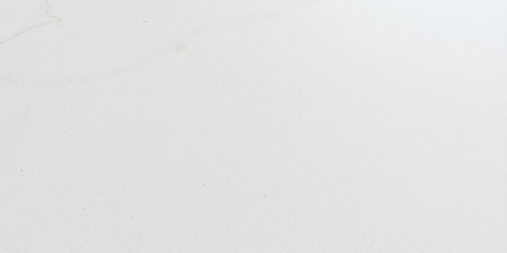 Close-up of smooth, matte honed marble tile surface.
