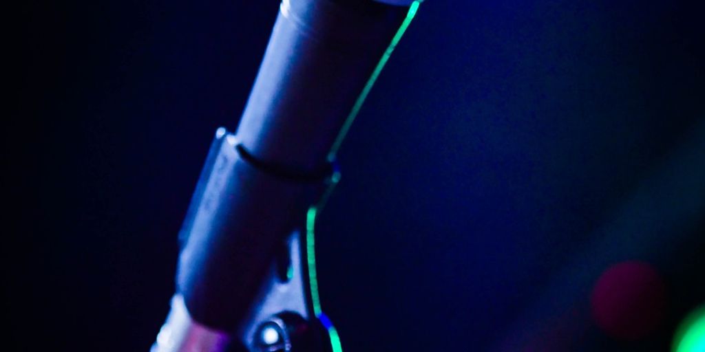 A close-up of a microphone with colorful blurred lights.