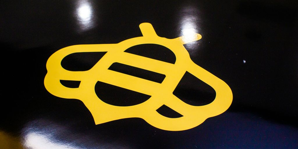 a close up of a yellow sticker on a black surface