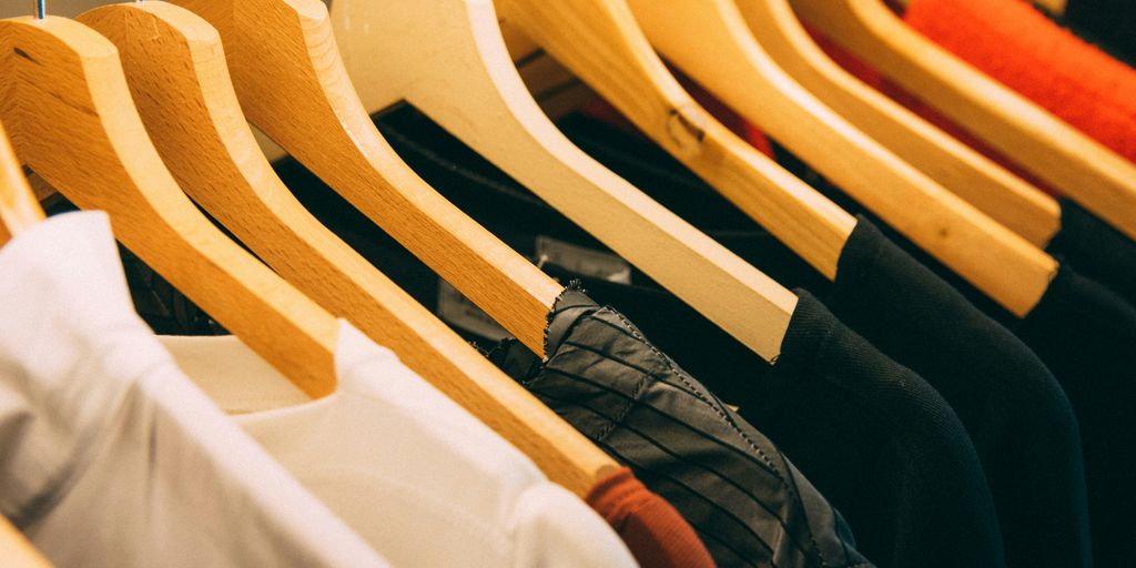 clothes hanged on brown wooden hanger
