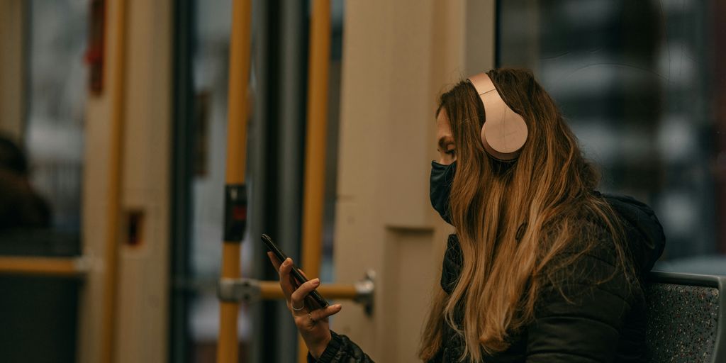 woman in black long sleeve shirt holding smartphone