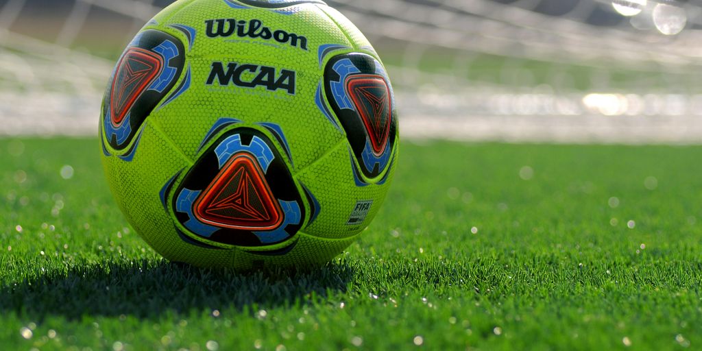 white green and blue soccer ball on green grass field during daytime